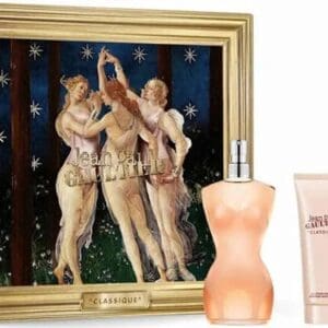 Jean Paul Gaultier Classique gift set featuring a gold-framed box with an artistic illustration of three women dancing under stars. In front of the box are the Classique torso-shaped perfume bottle, a matching body lotion, and a mini travel spray